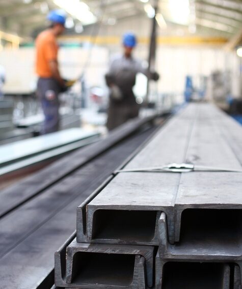 Stacked structural steel channels and beams inside a fabrication facility in Brooklyn, NY